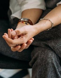 Person resting one of their hands in the other